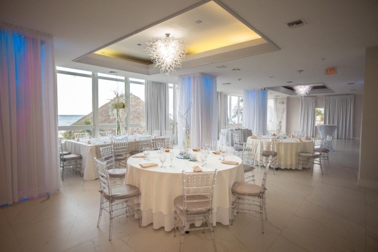 Airy white finishes, sculptural chandeliers and flexible table styling make space for a wedding that feels like you.