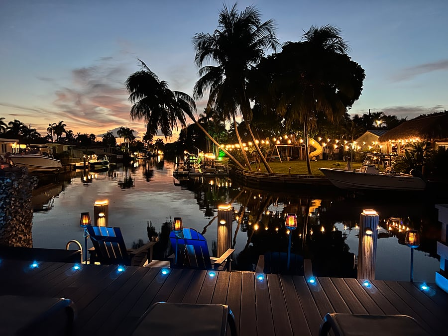 An intimate evening celebration at Tiki Sunset Waterfront Home under the palms