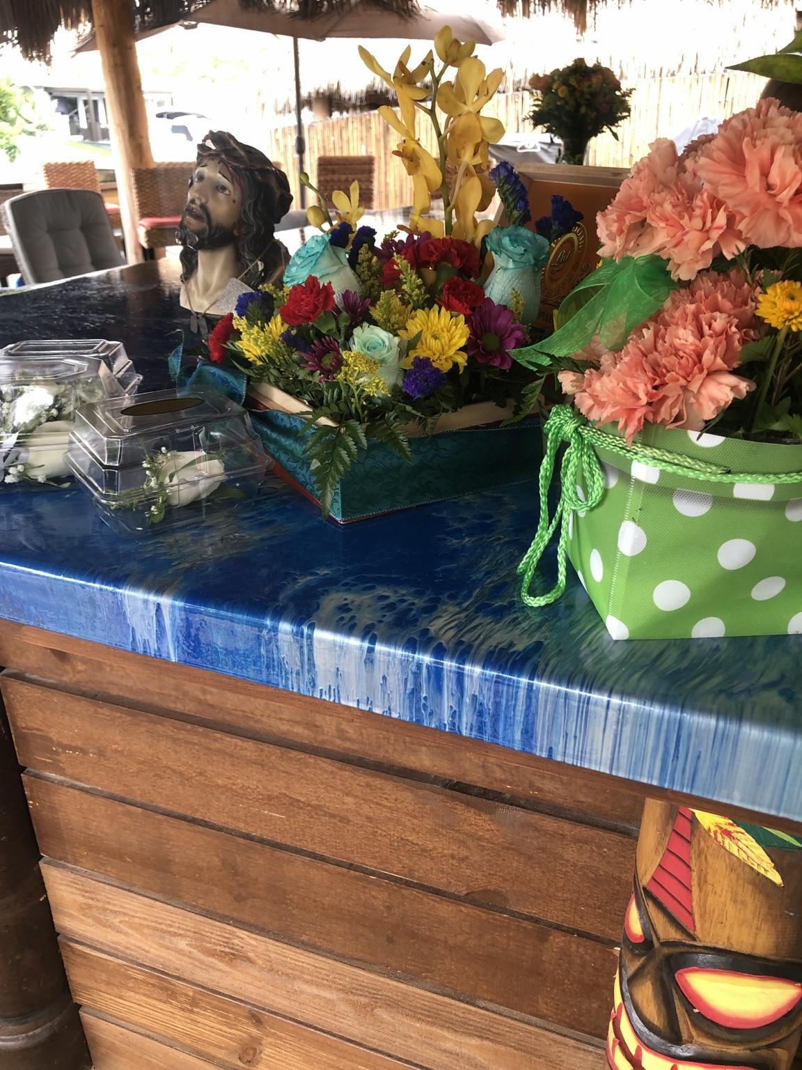 Bright flowers and thoughtful finishing touches bring a joyful splash of color to the tiki bar.