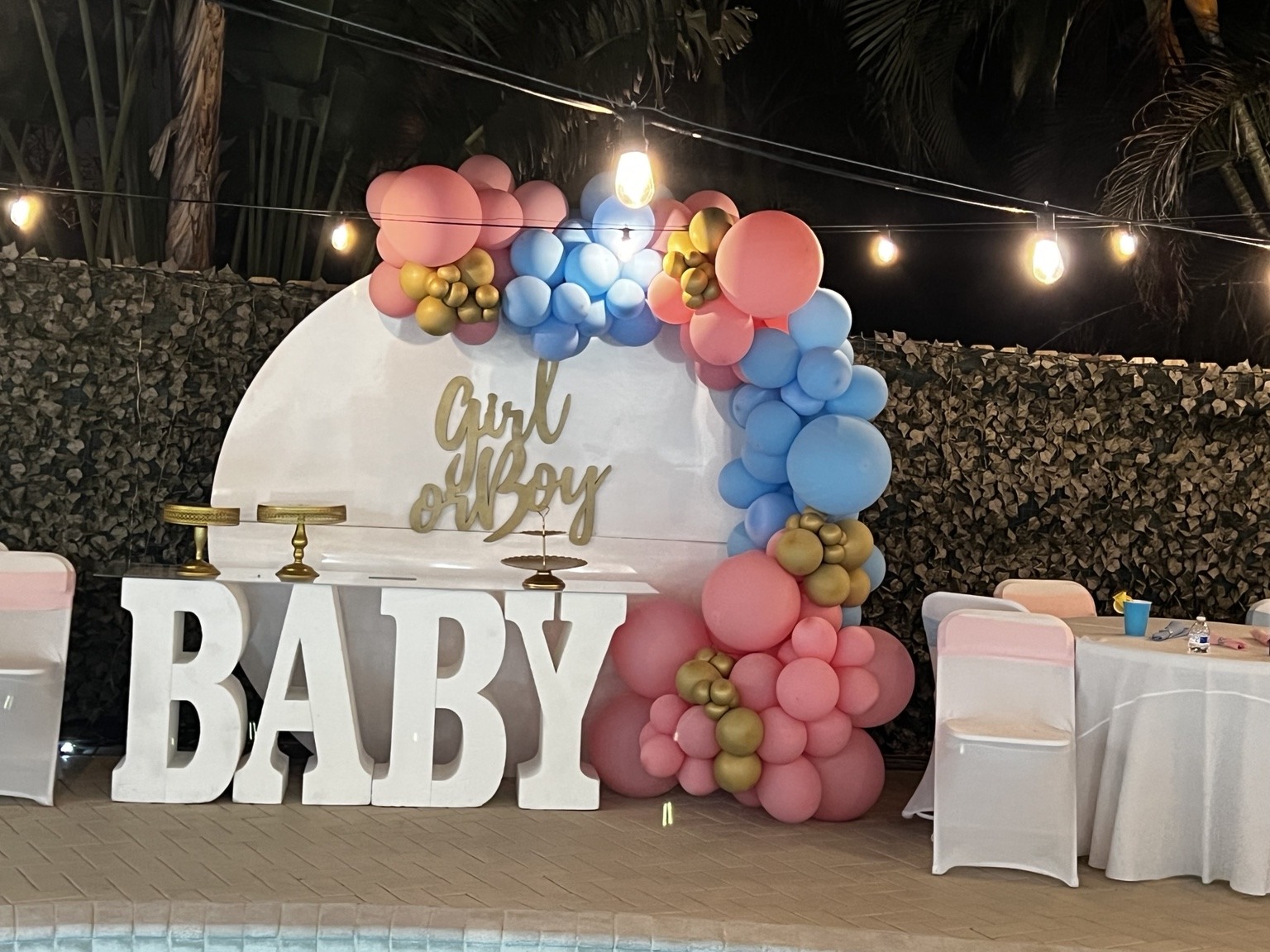Pink, blue and golden accents make a playful poolside welcome for a baby celebration full of anticipation and love.